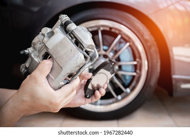 A Man Holding Standard Caliper And Brake Pad Spare Part In ีupgrade Service Maintenance Action Concept Brake System Of Car