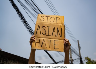 A man holding Stop Asian Hate sign - Shutterstock ID 1938990220