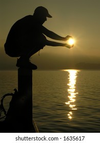 Man Holding The Sun