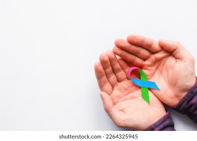 man holding a symbol of World AIDS Day - Shutterstock ID 2264325945
