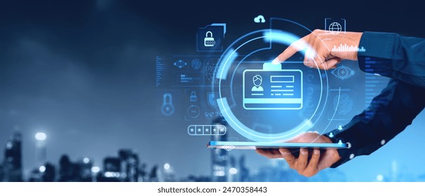 Man holding a tablet and finger touch glowing digital ID hologram, personal information and data statistics, empty background with blurred skyline. Concept of business profile privacy and access - Powered by Shutterstock