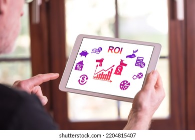 Man Holding A Tablet Showing Roi Concept