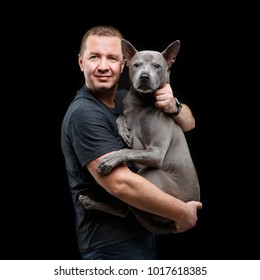 Man Holding Thai Ridgeback Dog