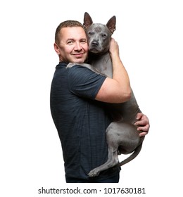 Man Holding Thai Ridgeback Dog