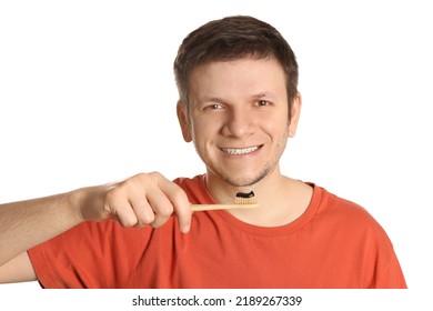 Man Holding Toothbrush With Charcoal Toothpaste On White Background