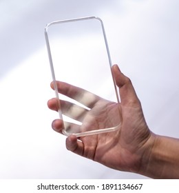 Man holding transparent mobile phone - Powered by Shutterstock