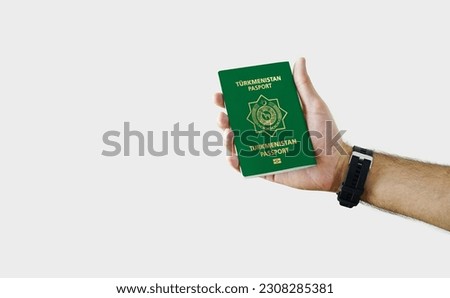 Man holding Turkmenistan Passport in hand on white background with copy space - Turkmen