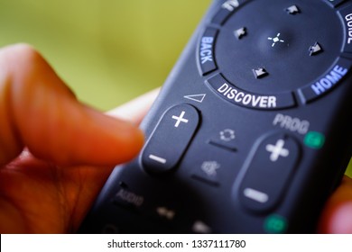 Man Holding Tv Remote Commander And Press Volume Down Button