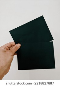 Man Holding Two Black Blank Cards Isolated On Grey Background