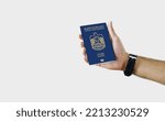 Man holding UAE Passport in hand on white background with copy space - Emirati - United Arab Emirates