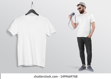 Man Holding Vintage Camera In White Crew Neck T Shirt Hand In Pocket Wearing Back Denim Jeans Pant Hanging T Shirt On Hanger