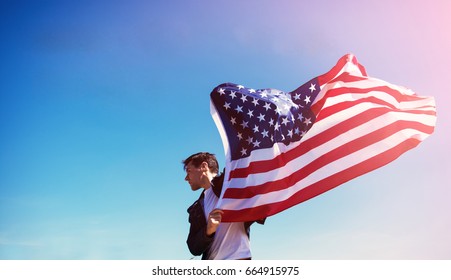 Man Is Holding Waving American USA Flag. 