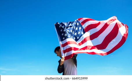 Man Is Holding Waving American USA Flag. 