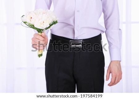 Similar – Man in jeans and plaid shirt with some white flowers in his hand