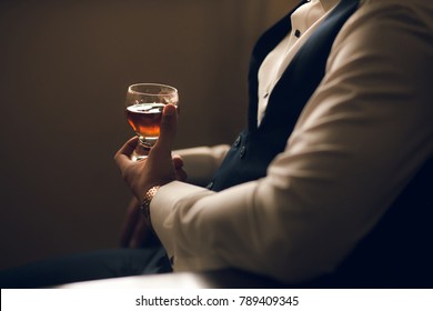 Man Holding Whiskey Glass In Hands