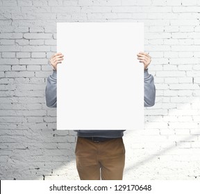 man holding white blank poster - Powered by Shutterstock