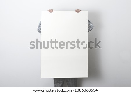 man holding white customizable empty poster