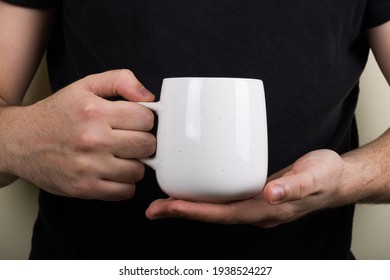 Man Holding White Mug. Place For Your Design And Text