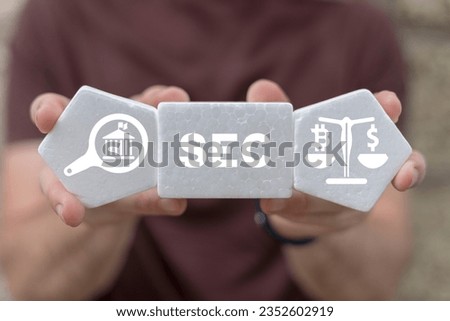 Man holding white plastic foam blocks with icons and sees acronym: SEC. Concept of Security Exchange Committee (SEC). SEC exercises control of Exchange Traded Fund (ETF).