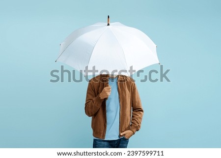 Man holding white stylish umbrella isolated on blue background 