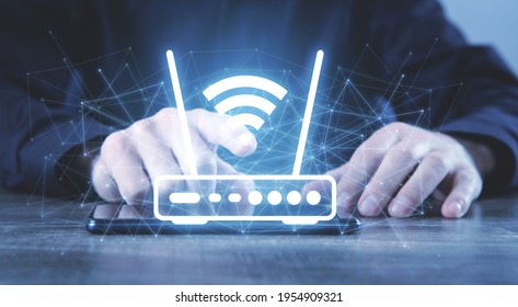 Man holding a Wifi router and network. - Shutterstock ID 1954909321