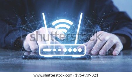 Man holding a Wifi router and network.