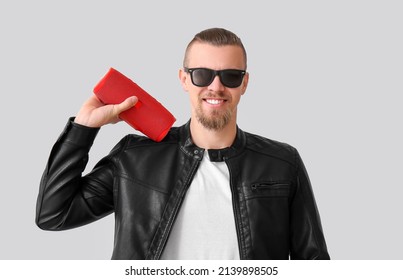 Man Holding Wireless Portable Speaker On Grey Background