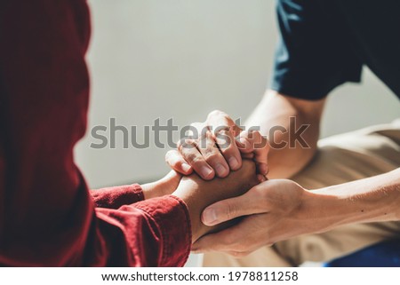 Man holding a woman's hand for warm, as psychological counseling concept of support, understanding care in love, Concept about encouraging and fighting problems.
