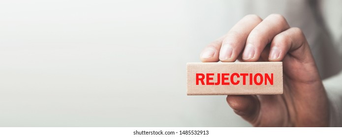 Man Holding Wooden Block. Rejection