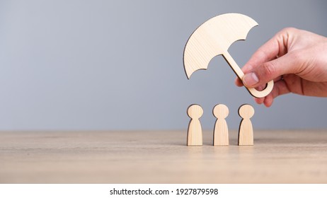 Man Holding Wooden Umbrella And People On Table