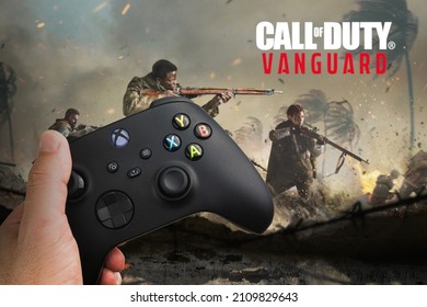 Man holding a Xbox Series S Carbon Black Controller with  Call of Duty Vanguard game blurred in the background. Rio de Janeiro, RJ, Brazil. December 2021.