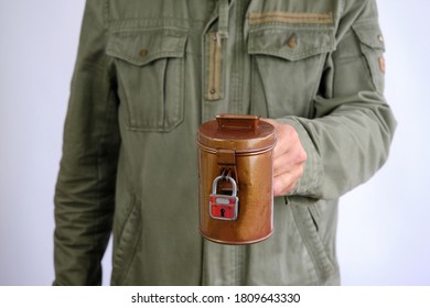 Man Holdiong A Vintage Money Collection Box With Padlock, Spendensose. Collect Money For A Good Cause. Isolated In White Background