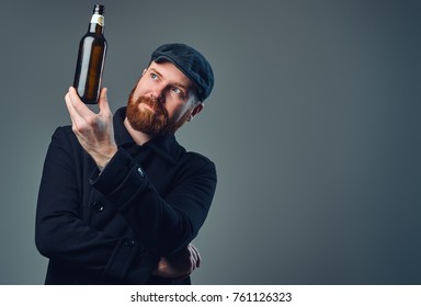 A Man Holds Beer Bottle.