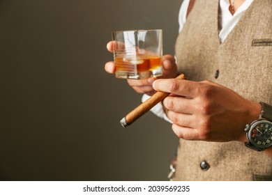 Man Holds Cigar And Glass Of Whiskey Close Up. Concept Of Cigar Club