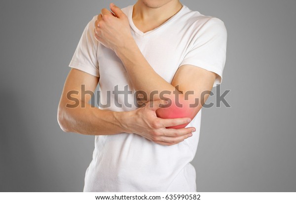 A man holds the elbow. The pain in my\
arm. A sore point in red. Closeup.\
Isolated.