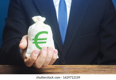 Man Holds Euro Money Bag. Granting Financing Business Project Or Education. Provision Cash Financial Credit. Profits Dividends. Donations And Philanthropy. Social Assistance. Investment. Award