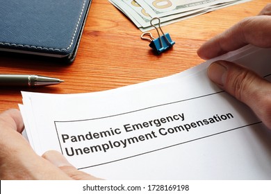 Man Holds Federal Pandemic Unemployment Compensation FPUC Documents.