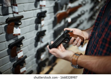 Man Holds Handgun In Gun Shop