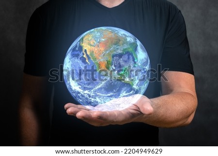 Man holds in his hand hologram of planet Earth. Earth in hands, Man holding blue Earth, Concept of communication network, internet of things and future life
