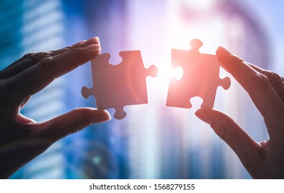 The man holds in his hand a jigsaw puzzle. Business solutions, success and strategy concept. - Shutterstock ID 1568279155