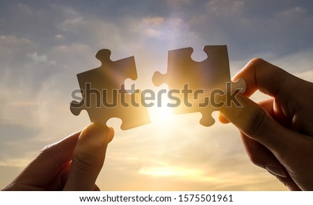 The man holds in his hand a jigsaw puzzle. Business solutions, success and strategy concept.