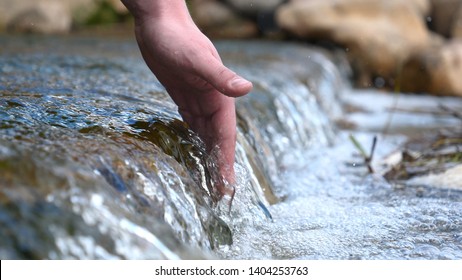 A Man Holds His Hand (washes His Hands) In The Fountain (water), Clearing Them Of Dirt, And Holding The Water Of The Waterfall In The Length Of His Hand. Concert Of: Feel The Water, Slow Motion.