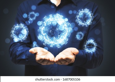 Man Holds In His Hands Blue Virus Cells. Concept Of Coronavirus. Healthcare And Immunology.