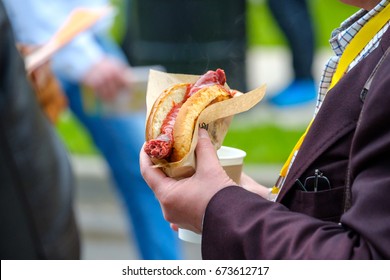 Man Holds Hotdog In The Hand