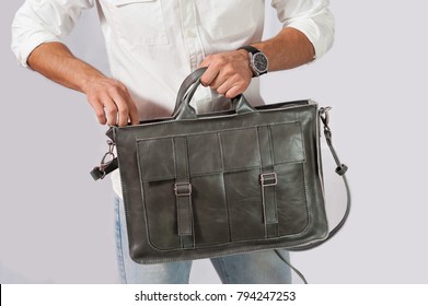 Man Holds Leather Bag