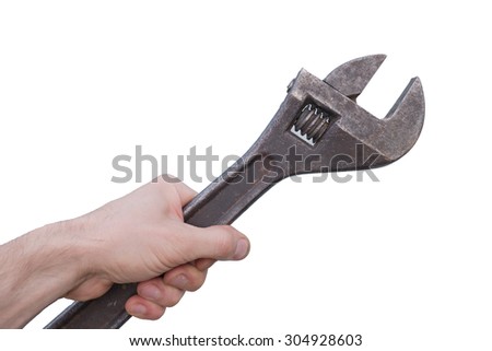 Man holds old rusty adjustable wrench in the hand. Image isolated from background. Shot with Panasonic G6 with 20 mm/1,7 lens, ISO 200.
