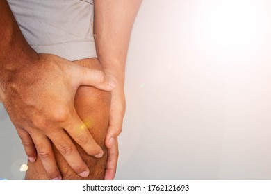 Man holds on to knee, pain in knee. People with knee pain and feeling bad hand on he knee, healthy concept.