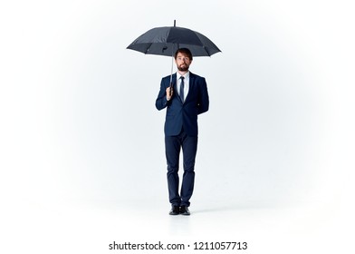 man holds open umbrella in his hand                             