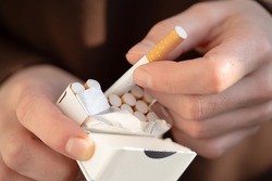 A Man Holds A Pack Of Cigarettes In His Hands, Hand With A Cigarette Closeup. Person With A Bad Habit That Is Unhealthy