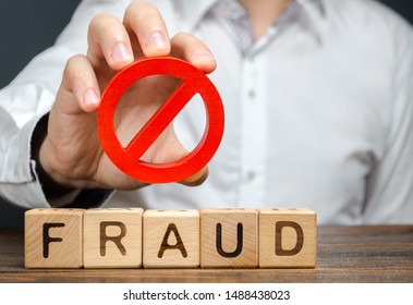 A man holds a red NO prohibition symbol over word fraud. Countering deception, protection against fraudsters. The fight corruption, financial pyramids and business scams. War on crime. Cheaters - Shutterstock ID 1488438023